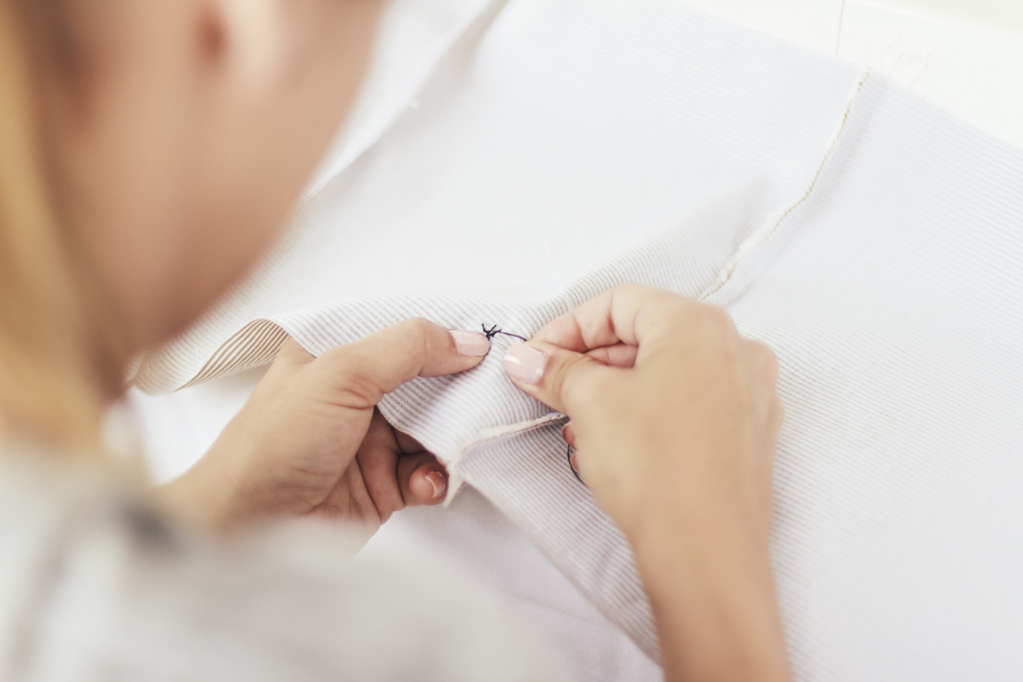Hands stitching a quick satin stitch